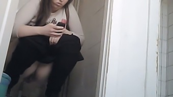 Chunky White Brunette Lady Texting And Pissing In The Toilet