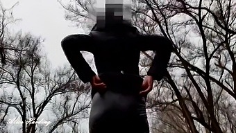 A Girl With A Beautiful Booty Walks In An Autumn Park In Leather Pants And Sometimes Shows Her Boobs